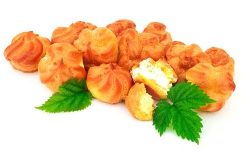 Group baked eclair, custard, cake, profiterole, bread with green leaves. Isol Stock Photos