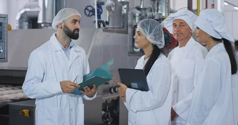 Group of bakery industry workers engineer explaining the plan of security for Video stock 112151233