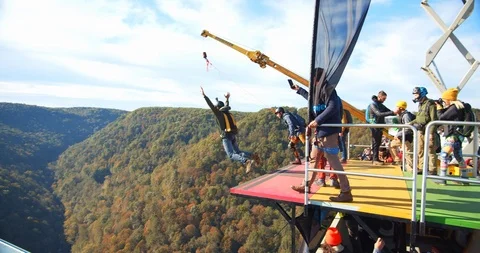Group Base Jumping, Jump Off Platform with Parachute, Slow Motion Video stock 127466887
