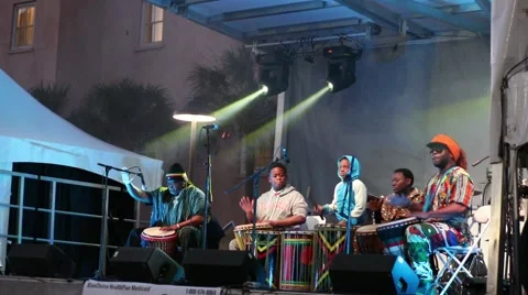 Group beating drums under neon lights Stock Footage 45565430