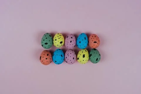 Group of beautiful painted Easter eggs isolated on pink background. Quail eggs Stock Photos