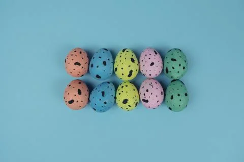 Group of beautiful painted Easter eggs isolated on blue background. Quail eggs Stock Photos