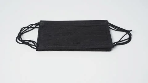 Group of black Disposable Ear- loop face mask on white background. Stock Photos