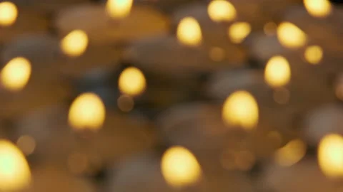 A group of blurred abstract tea lights with warm orange yellow flames Stock Footage 220266553