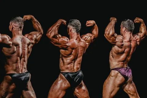 Group bodybuilder athlete show back double biceps for bodybuilding competitio Stock Photos