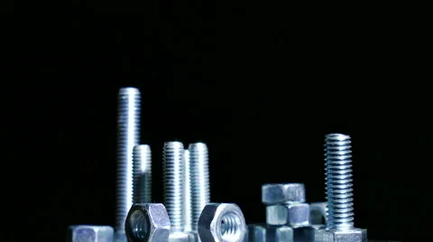 Group of  bolts , nuts rotates against  dark background. 4K   shot Stock-Footage 61459161