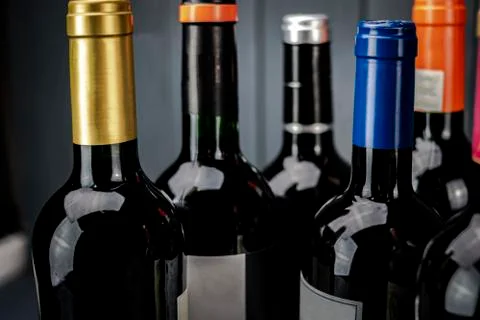 Group of bottles of red wine of different brands and colored labels to be tas Stock Photos