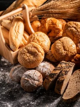 A group of bread on the black wooden table with sunlight Stock Photos