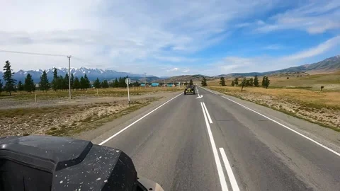 A group of buggies and ATVs rides on an asphalt road. Timelapse Stock Footage 161246908