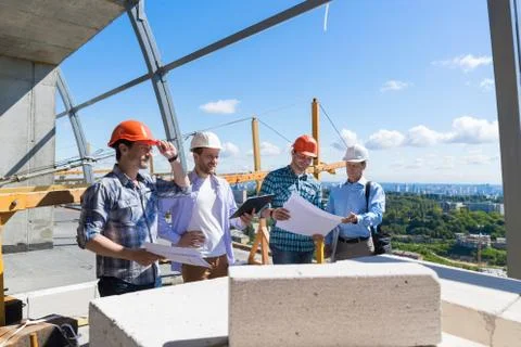 Group Of Builders On Construction Site Building Team Of Apprentices Meeting With Stock Photos