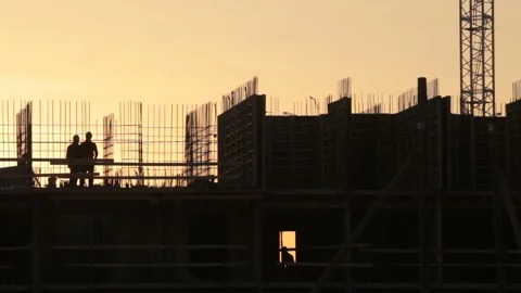 A group of builders discussing something on the site Stock Footage 88503235
