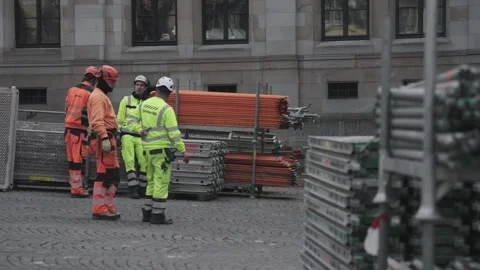 Group of builders in high visibility clothing discussing work next to 스톡 동영상 332649784