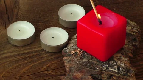 Group of burning candles on wooden background Stock Footage