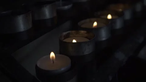 Group of burning tea light candles in a church. Slow motion tracking movement Video stock 170516008