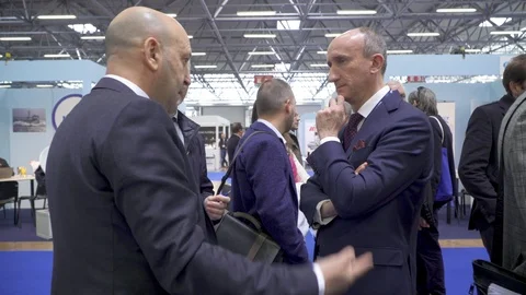 Group of business men in suits talking at convention Stock Footage 88544748