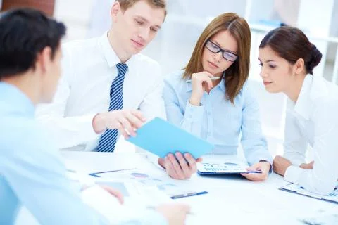 Group of business partners interacting while planning work at meeting Foto stock