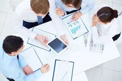 Group of business partners interacting while planning work at meeting Foto stock