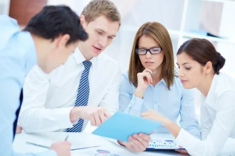 Group of business partners interacting while planning work at meeting Stock Photos