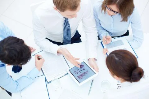 Group of business partners interacting while planning work at meeting Foto stock