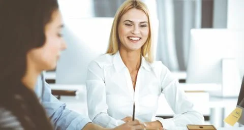 Group of business people discussing questions at meeting. Headshot of blonde Stock Photos