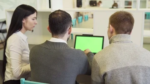 Group of business people discussing something on a green screen laptop Stock Footage