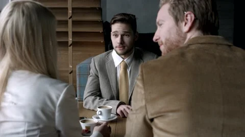 Group of business people having a chat at a cafe. Stock Footage 61157579