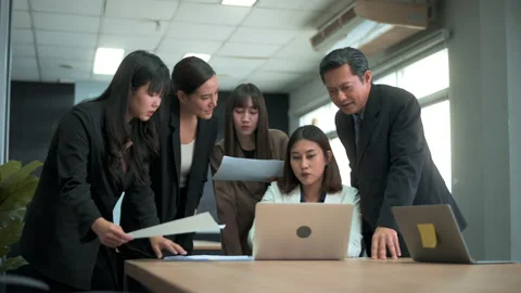 Group of business people looking at computer and discussing in modern office Stock Footage 168115701