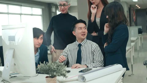 Group of business people looking at computer and discussing in modern office Stock Footage 168115812