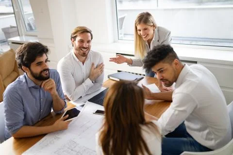 Group of business people meeting in office, sharing their ideas. Stock Photos