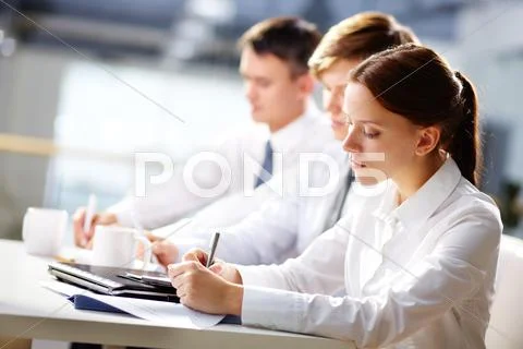 Group of business people taking notes at training Stock Photos
