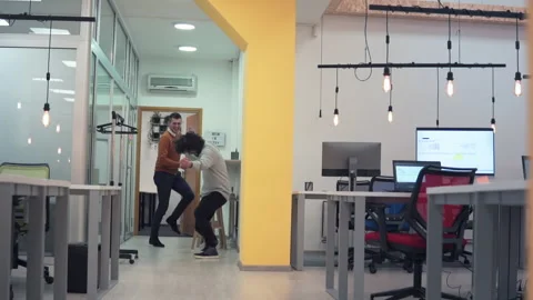 Group of business professionals dancing in office celebrating a successful pr Stock Footage 236659376