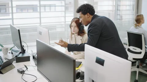 A group of business professionals engaged in a collaborative meeting in a modern Stock Footage 280630908