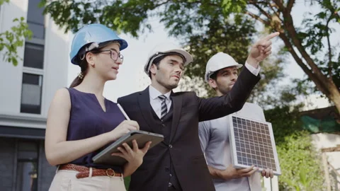 Group of businessmen and meeting engineers to install solar panels in building.  Stock Footage 150225053