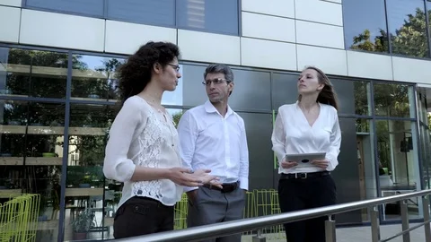 Group of businessmen on the background of the office center Stock Footage