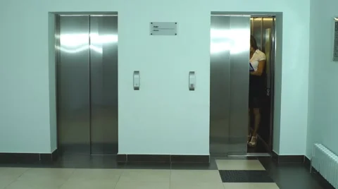 A group of businessmen coming out of the Elevator and discuss the business plan Stock Footage 67494729