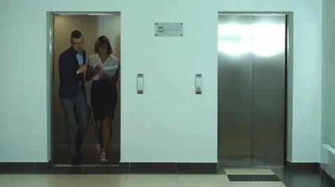 A group of businessmen coming out of the Elevator Stock Footage 67496014