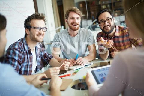 Group of businessmen talking to co-worker at briefing Stock Photos