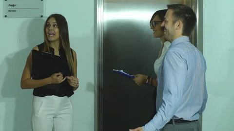A group of businessmen walks to the Elevator Stock Footage 67550670