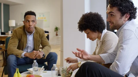 Group of businesspeople talking while having meal in office Stock Footage 93524969