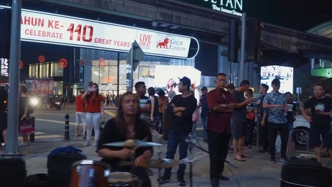 A group of buskers performing at Bukit Bintang street in public place Stock Footage 105722731