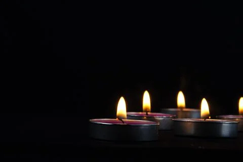 Group of Candles of peace with dark background and yellow flame sue as peac.. Stock Photos