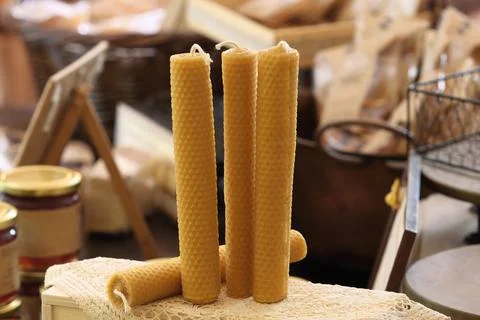 Group of candles placed vertically on a doily on a table 스톡 사진