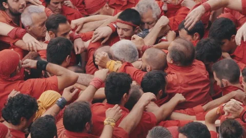 Group of castellers forming the first strong layer to build a human tower Stock Footage 178374033