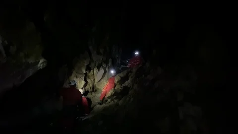 Group caving adventure climbing down cave in Banff Canada Stock Footage 122099663