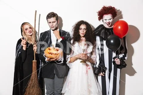 Group of cheerful friends dressed in scary costumes Stock Photos