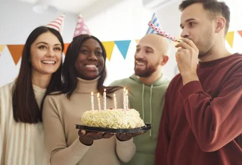 Group of cheerful optimistic friends having fun on birthday party Stock Photos