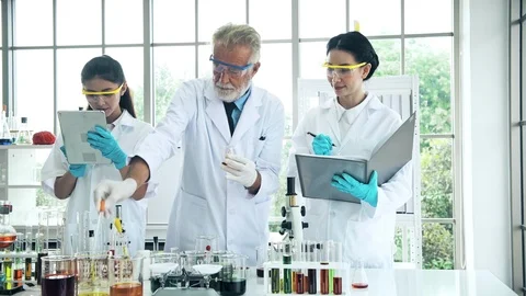 Group of chemist working in a lab, discussing work. Stock Footage 99013804