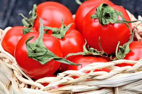 Group of cherry tomatoes in a wicker Stock Photos