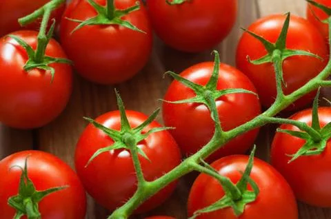 Group of cherry tomatos on rustic fabric. Organic vegetables background.Close up Stock Photos