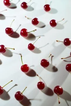 Group of cherry on a white background with shadows. Close-up. Top view. Stock Photos
